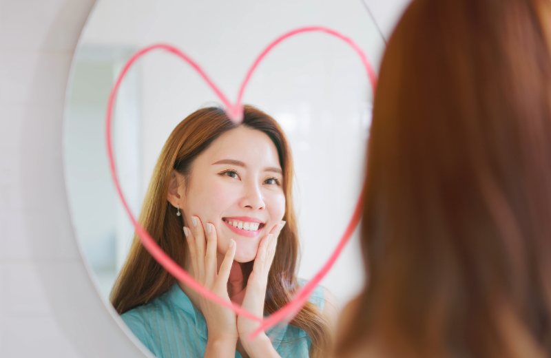 An image of someone looking at themself in the mirror.