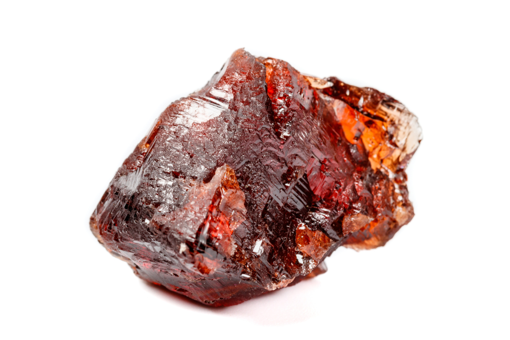 A piece of Spessartine Garnet on a white background