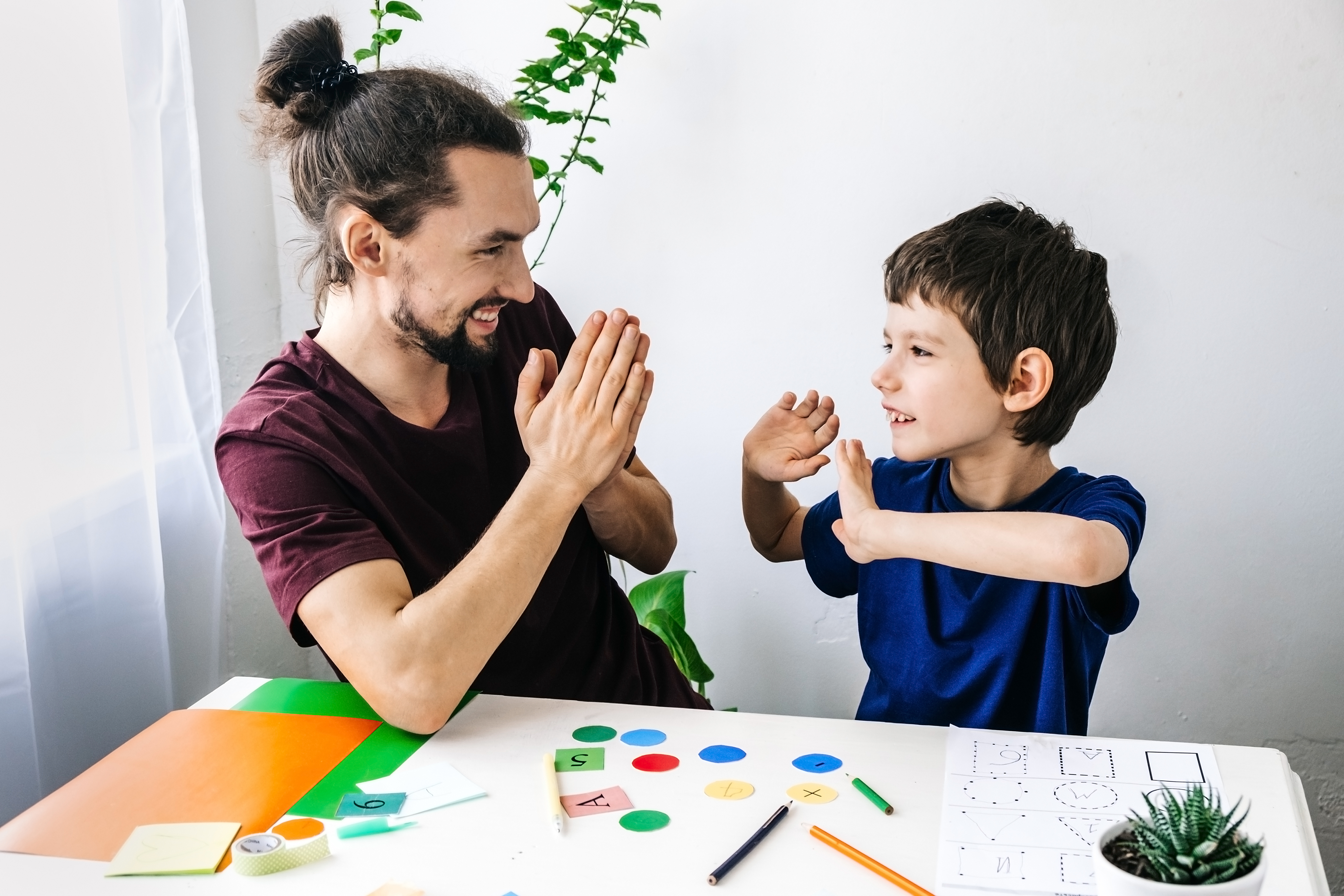 Father giving autistic son high five