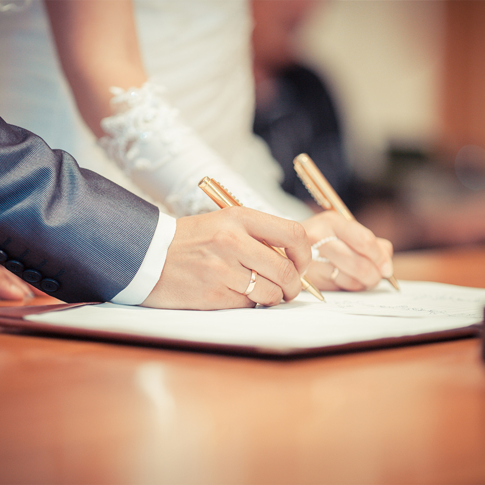 Wedding couple signing a marriage schedule