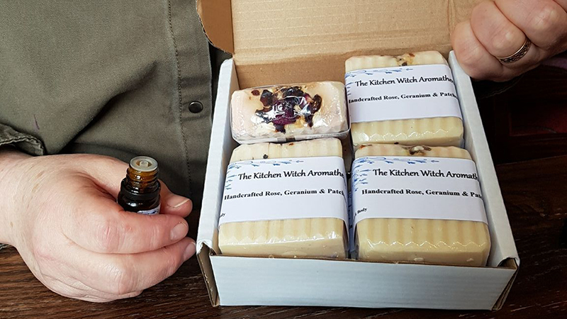 Michelle holding open a box of handmade soaps