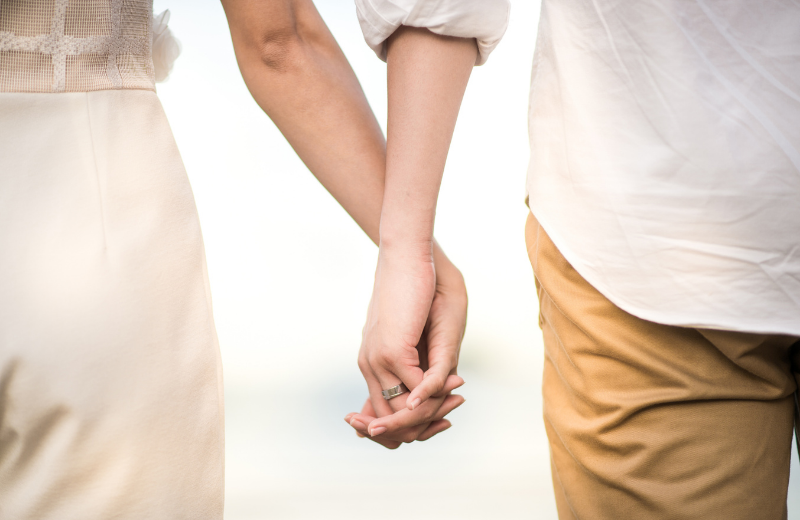 married couple holding hands