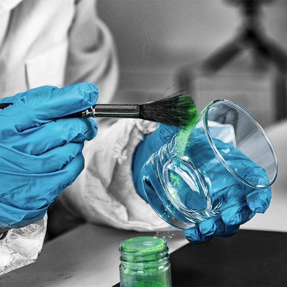 Forensic investigator examining a glass taken from a crime scene