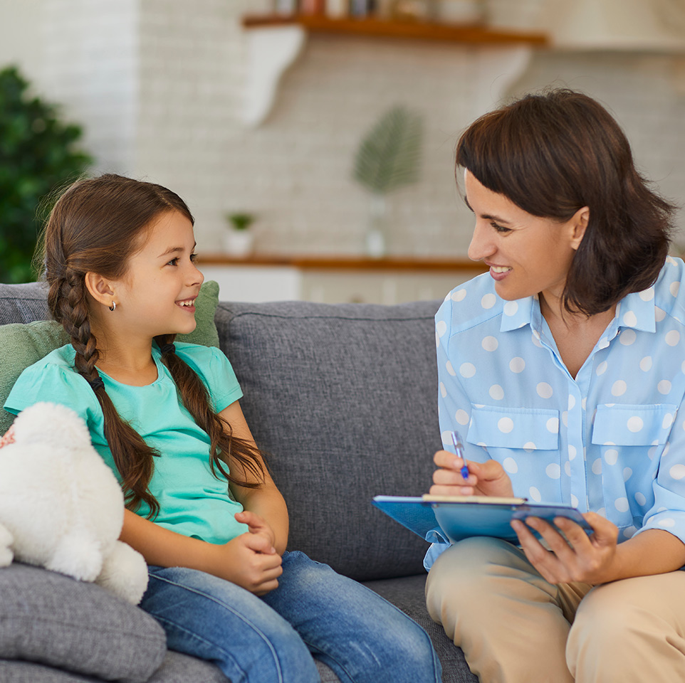 Child counsellor offering support to a child during a counselling session