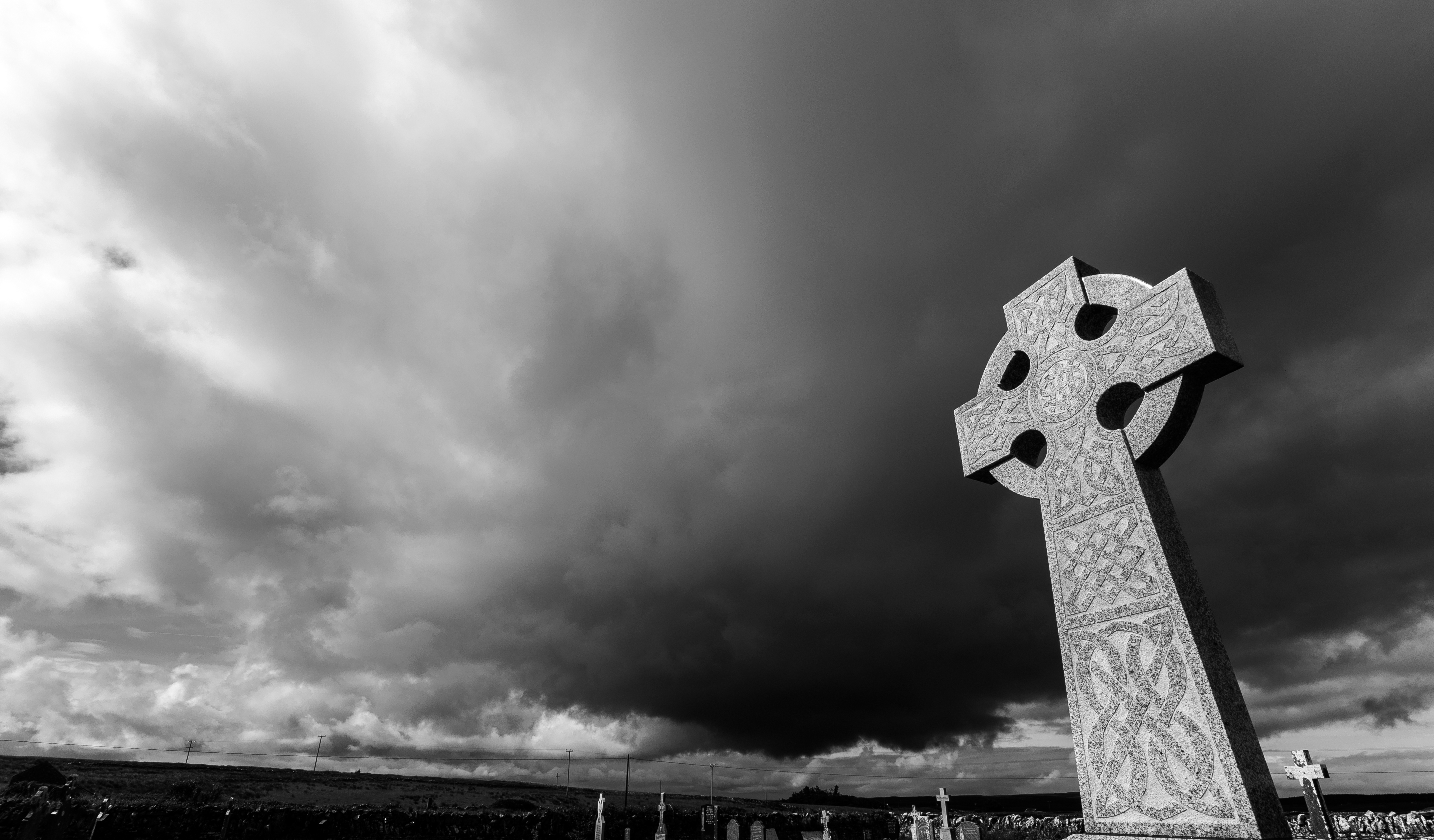 Creepy black and white graveyard with storm clouds