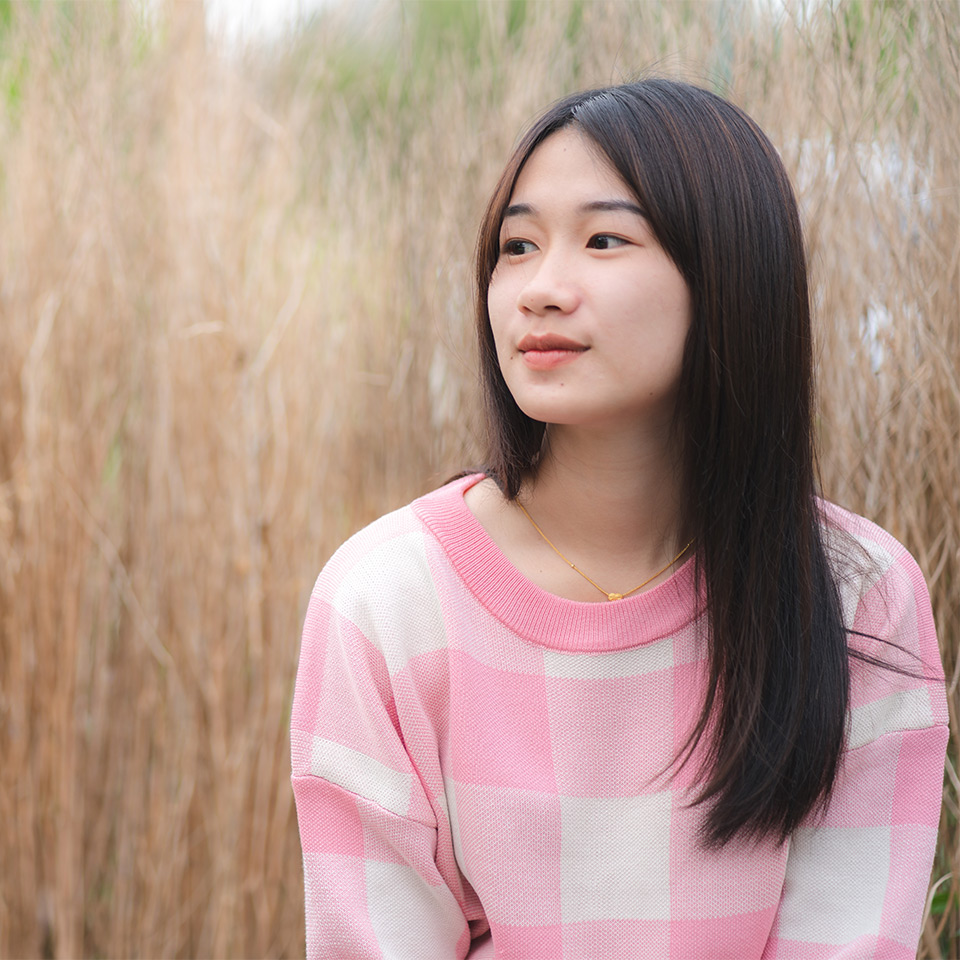 Woman sitting a field, considering her mental health