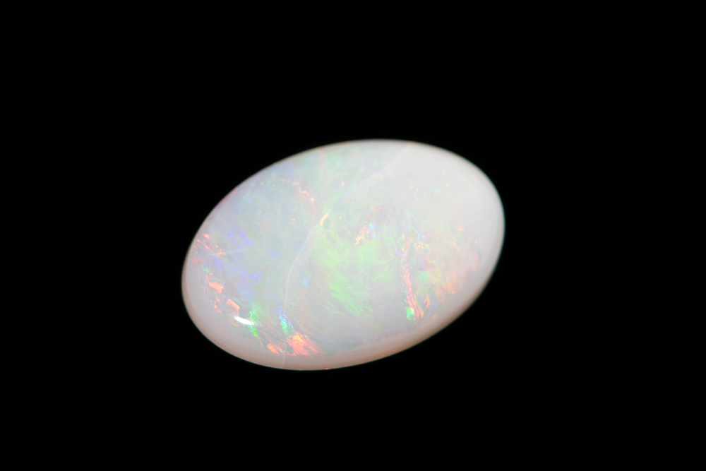 A piece of Opal on a black background