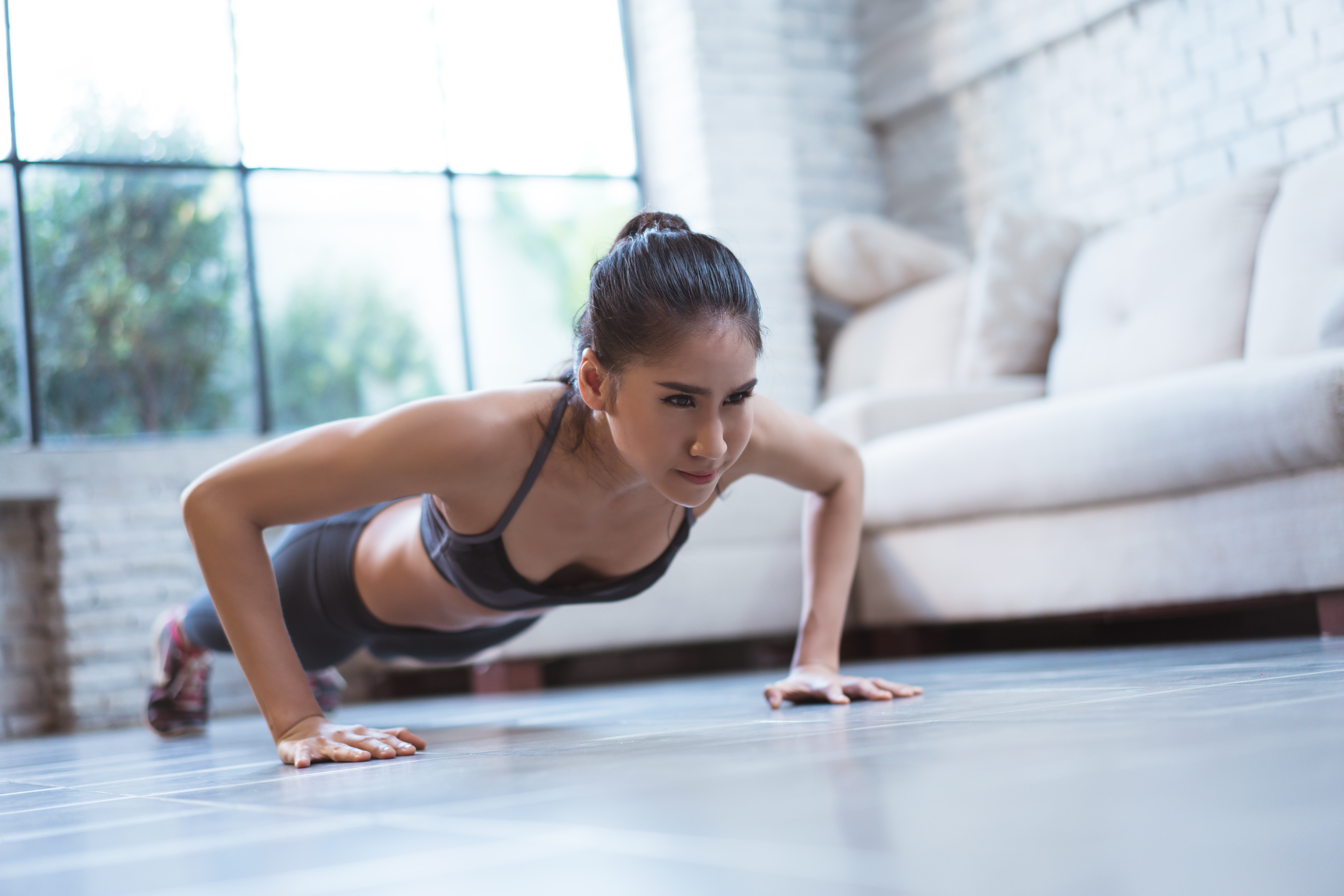 Woman doing push ups in living room