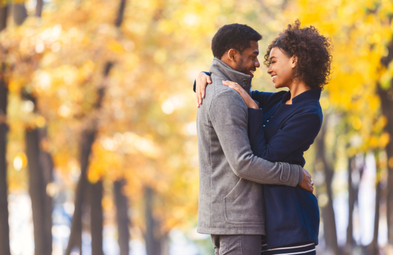 Image of a couple hugging outdoors.