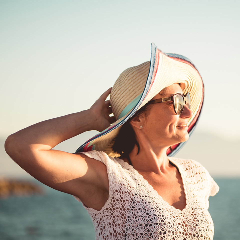 Profile of a happy woman on a beach looking into the distance
