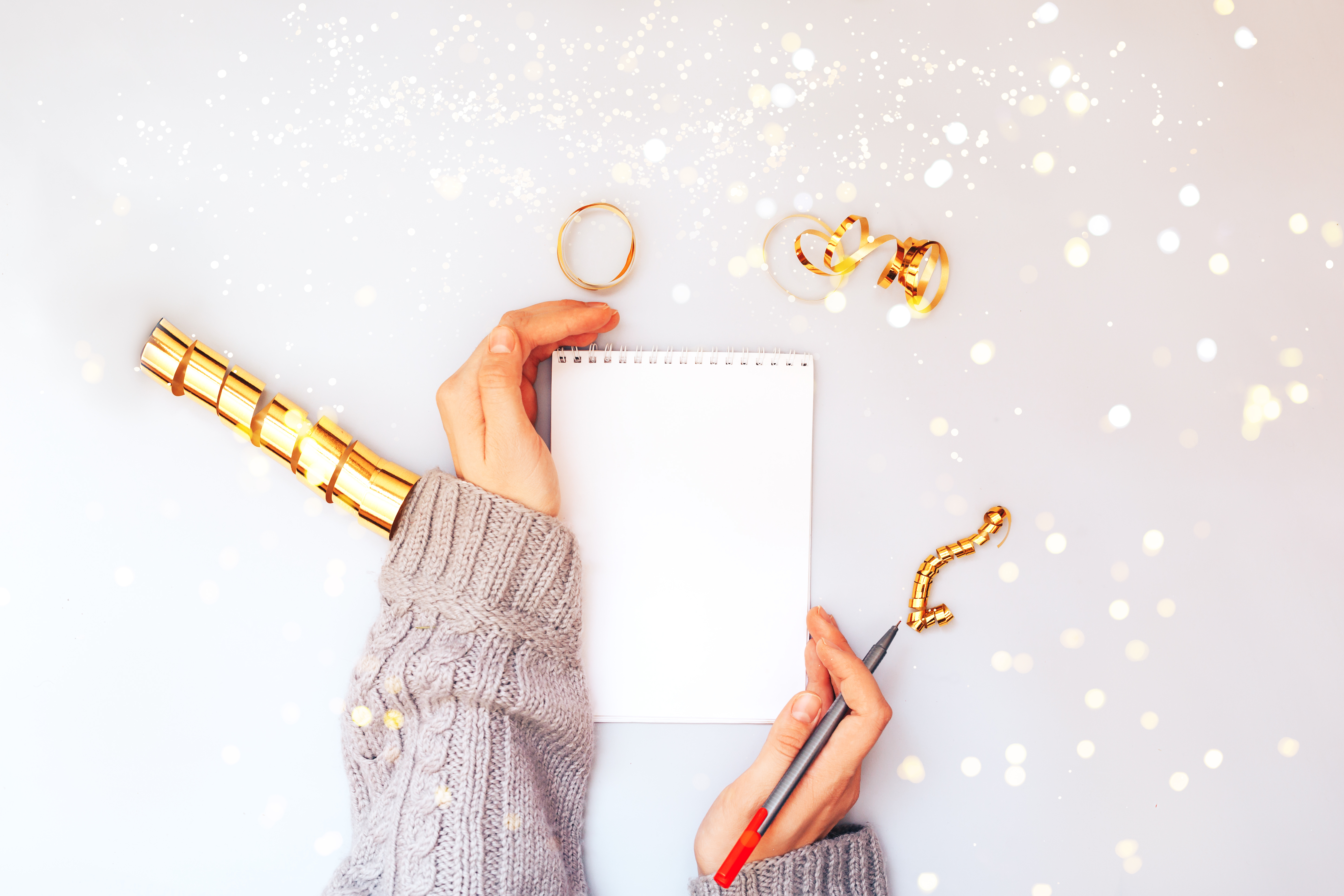 Image of someone with an empty notebook and pen, ready to write in it