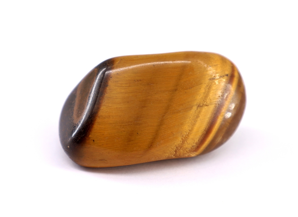 A piece of Tiger's Eye on a white background