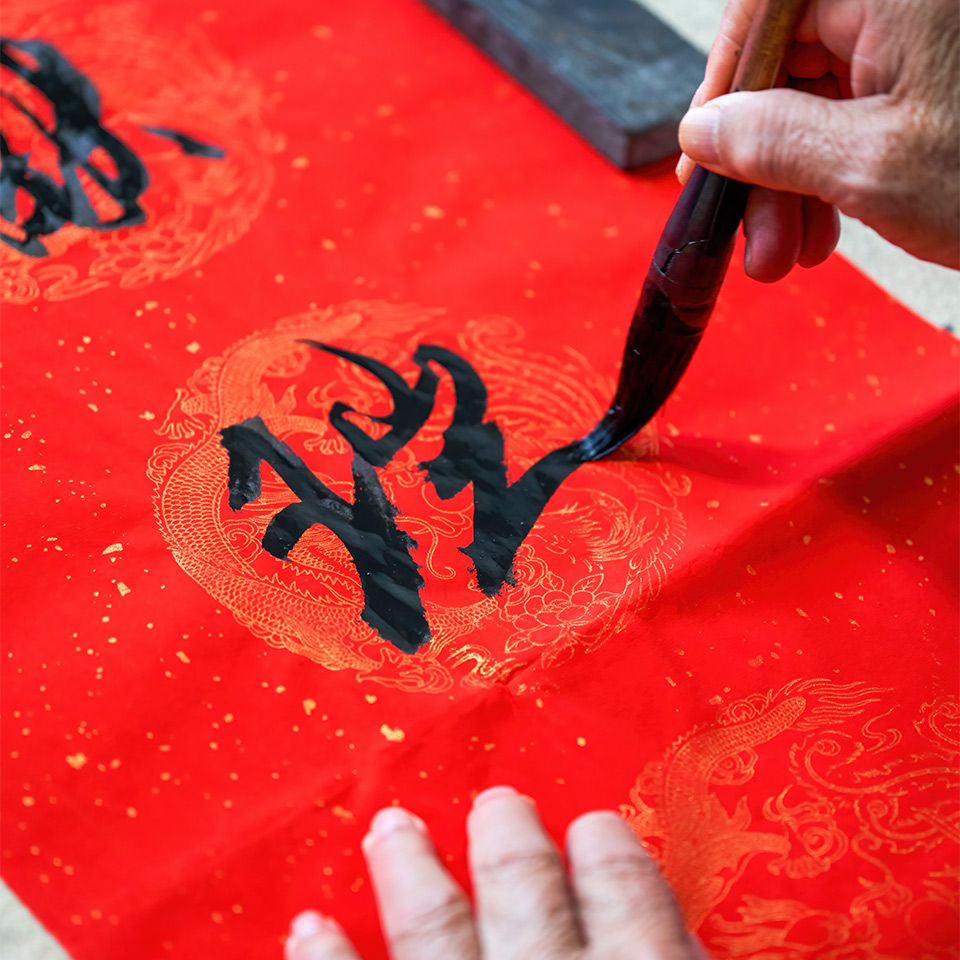 Hands writing in calligrapher