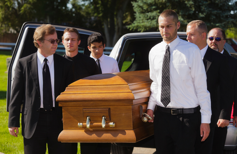 Image of people wearing black to a funeral.