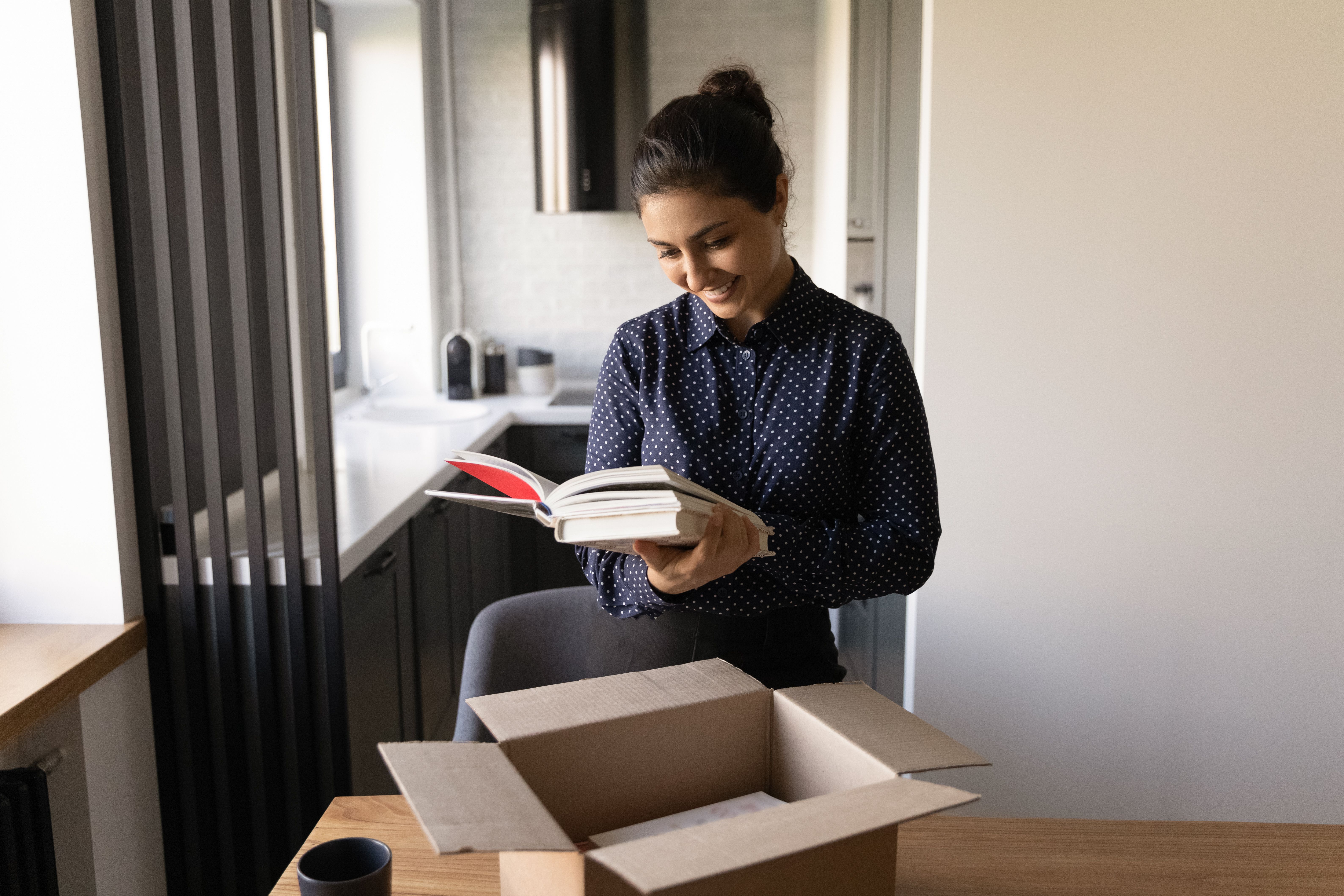 Woman taking published book from box