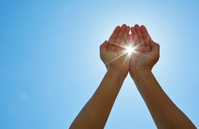 sun shining through hands