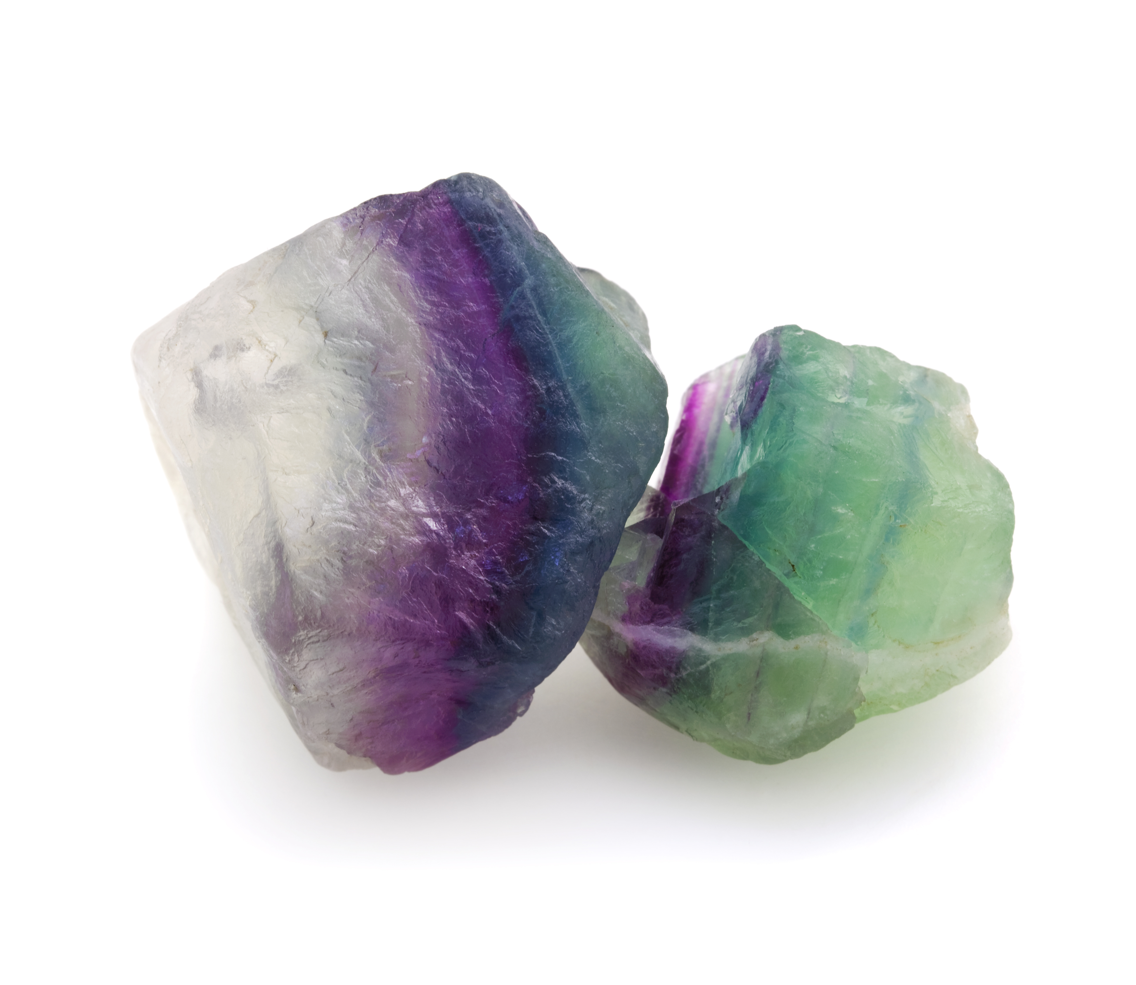 Two pieces of Fluorite on a white background