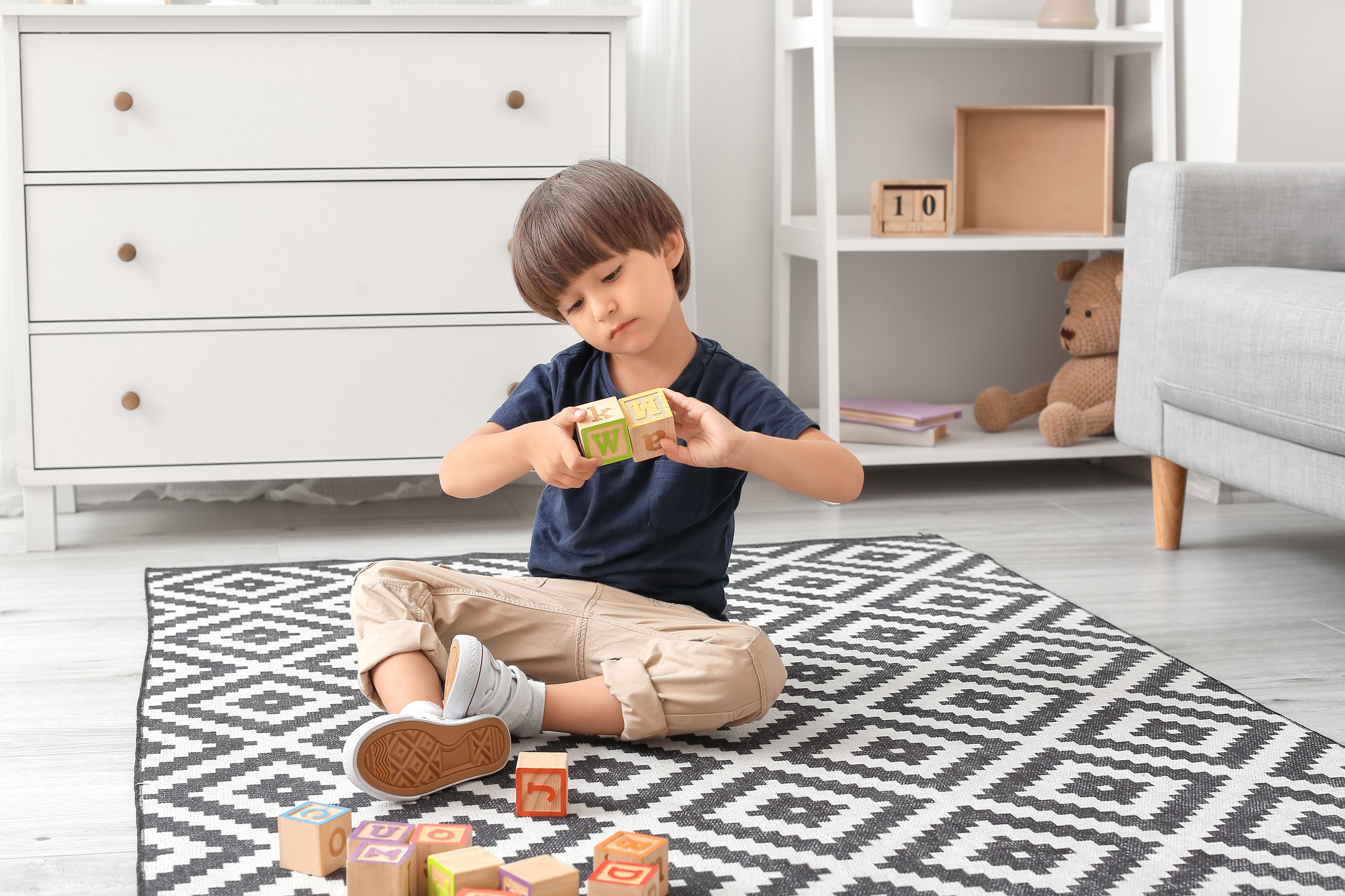 Autistic little boy playing with blocks