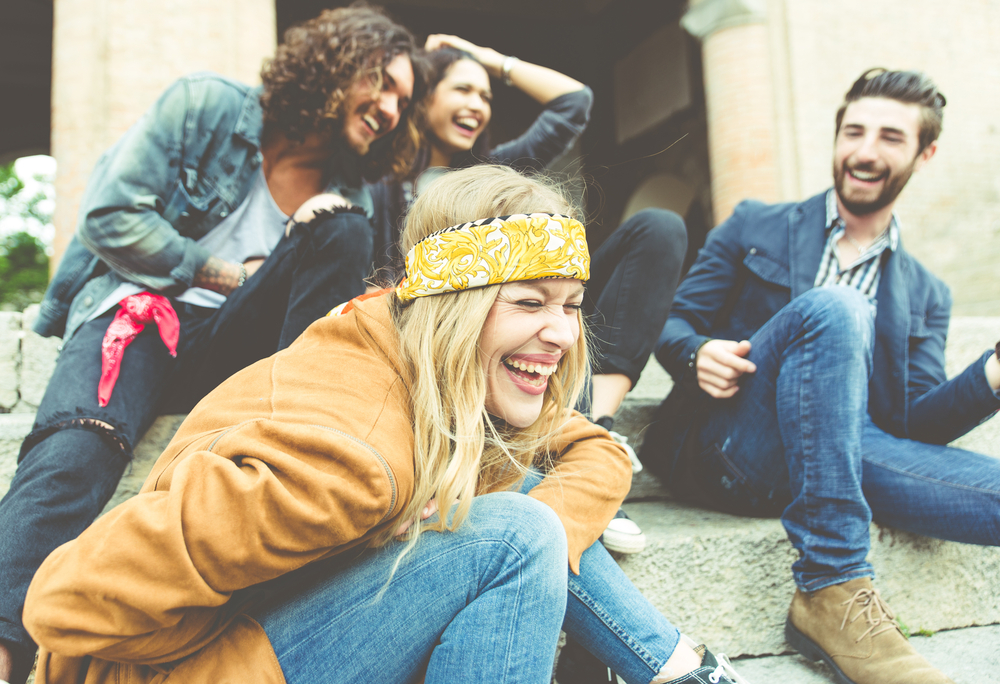 Group of friends laughing together in the street