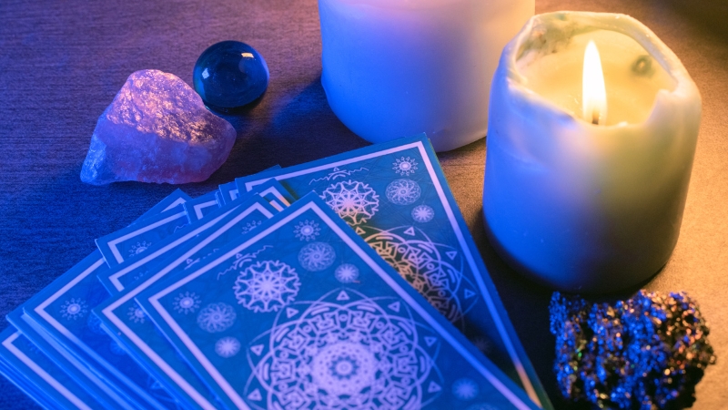 Tarot cards next to a candle