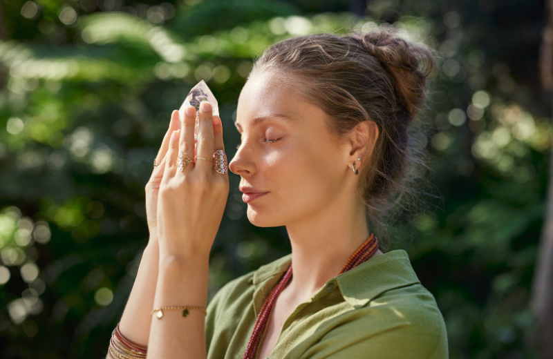 person meditating with clear quartz