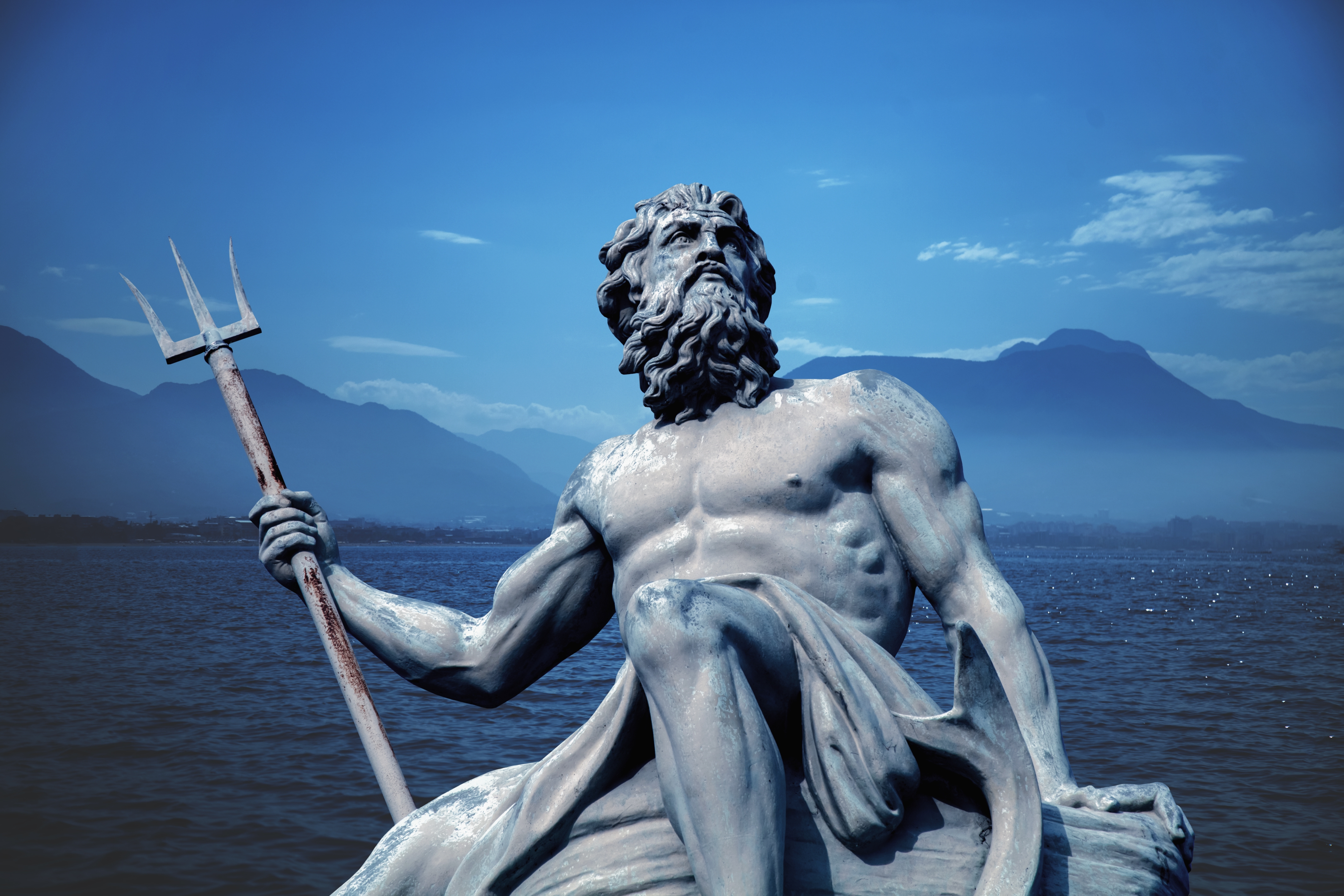 Poseidon with his trident in front of the sea