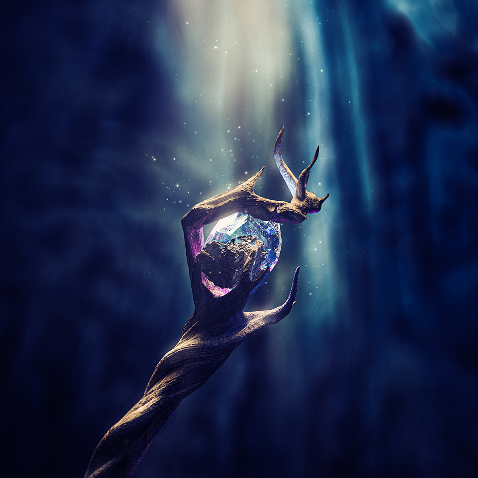 Magical wizard staff with a glowing gemstone in a dark cave