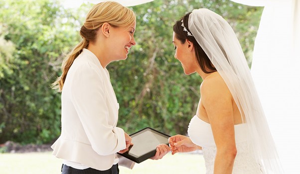 A wedding planner talking to the bride to be.