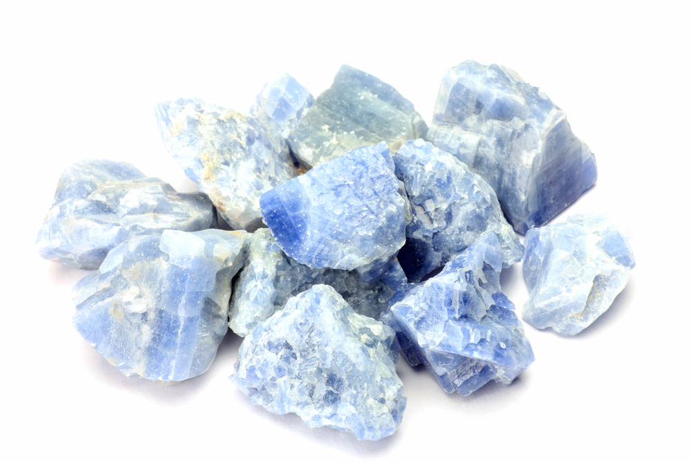 Multiple pieces of Blue Calcite on a white background