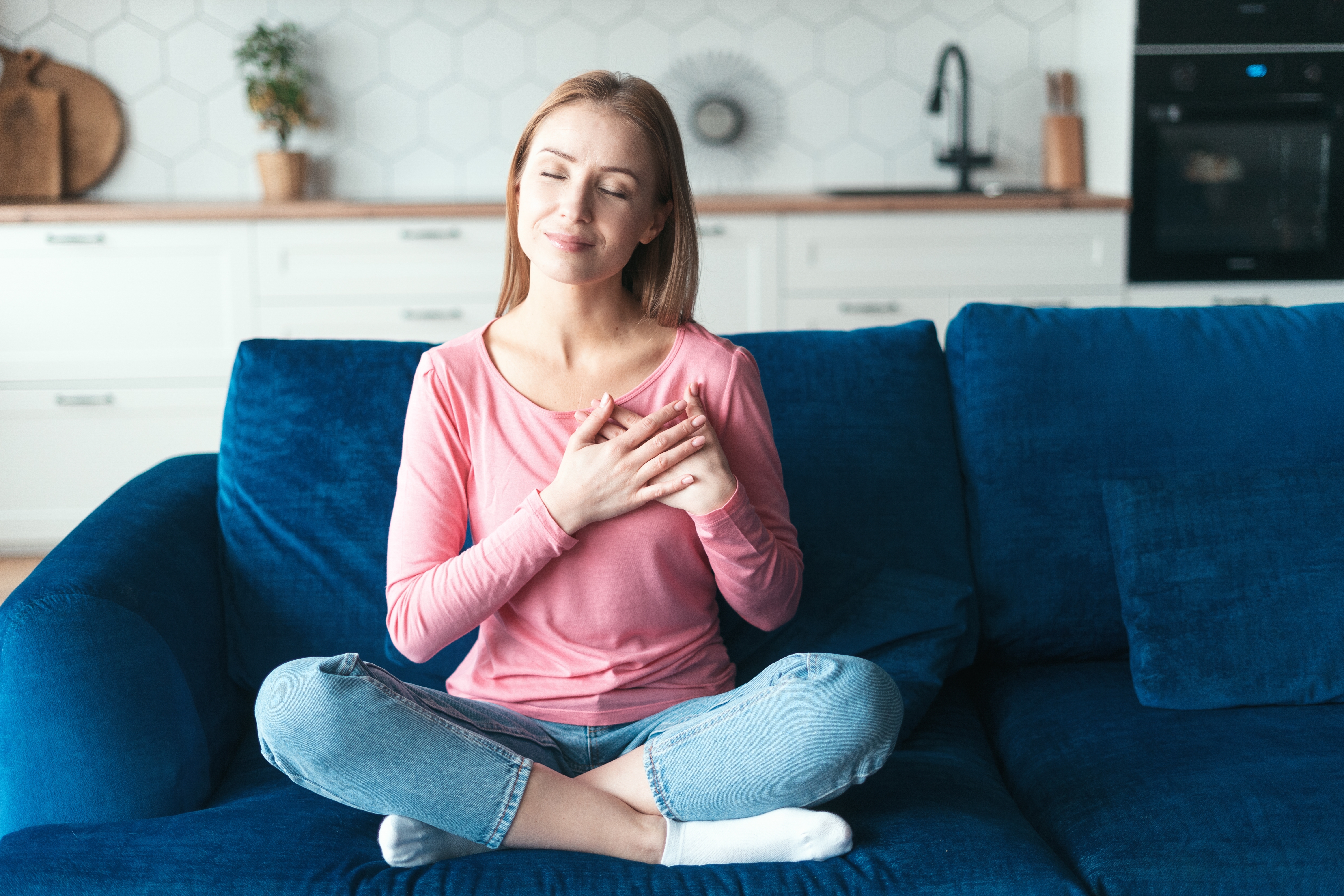 Woman with hands on heart, self love and meditation