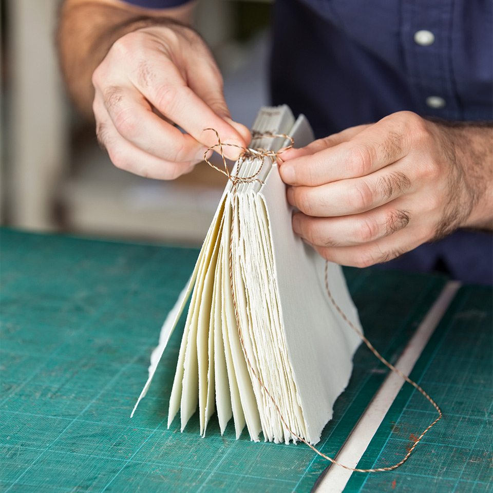 Hands in the process of book binding