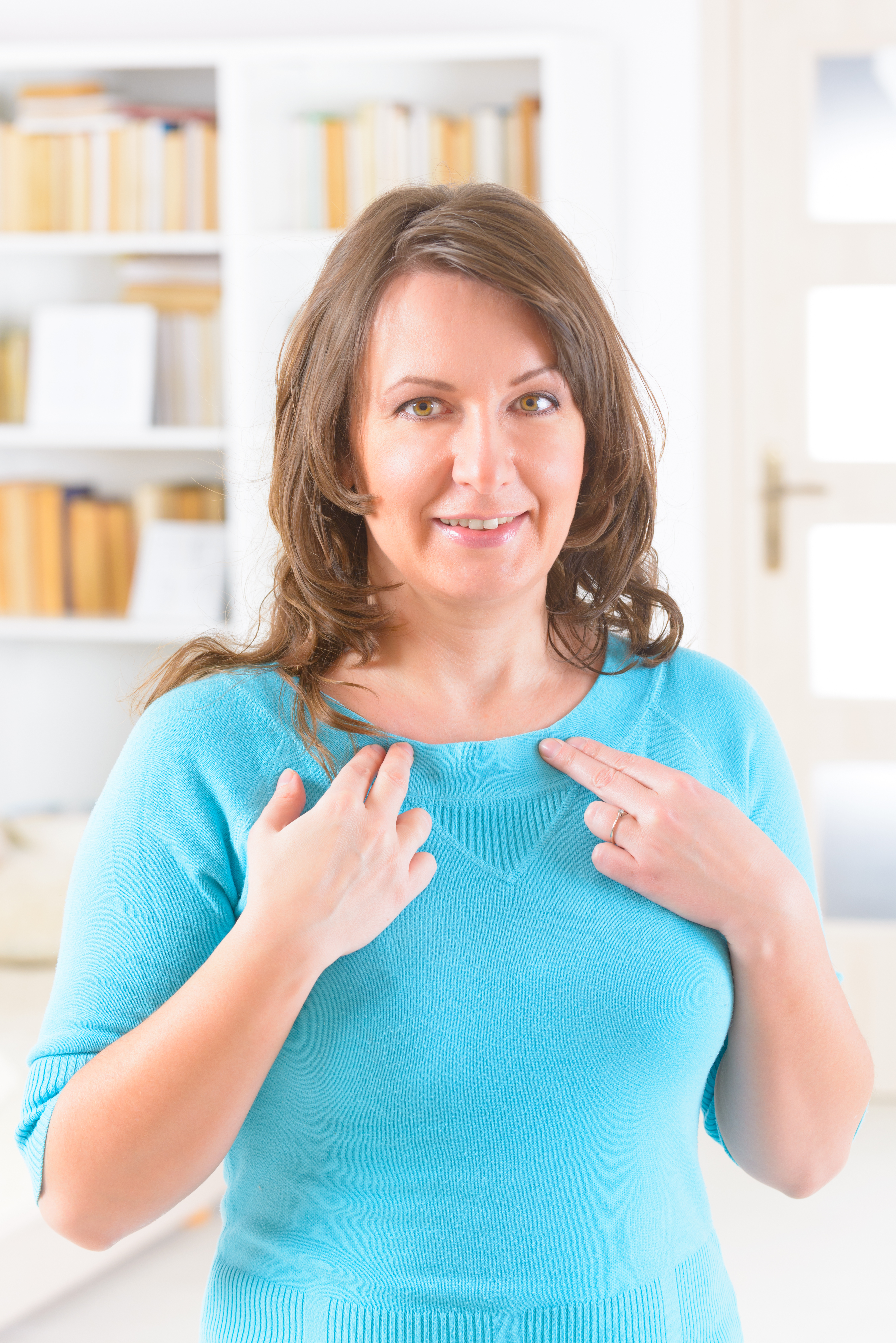 Woman tapping her collarbone