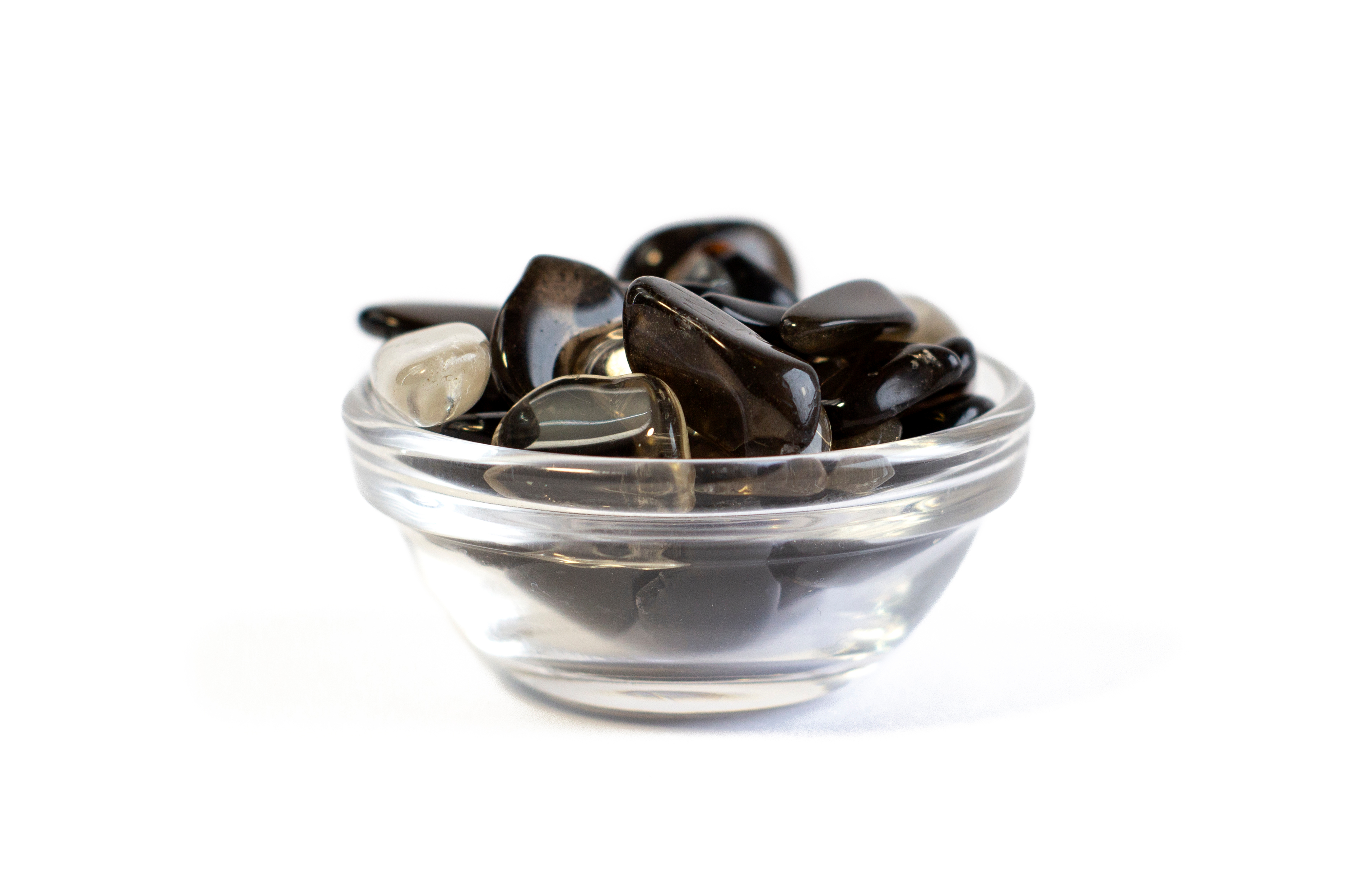 Clear bowl with lots of pieces of smoky quartz inside of it