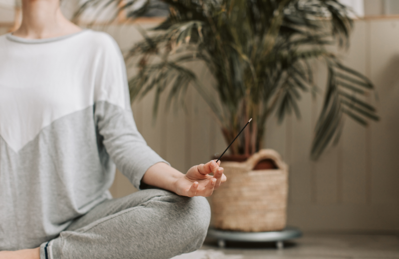woman meditating with incense