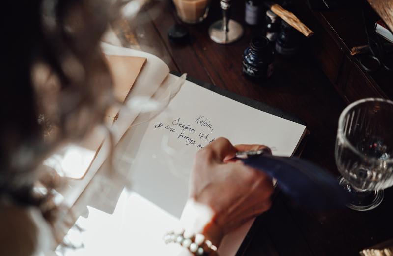 overhead shot of woman writing in notebook