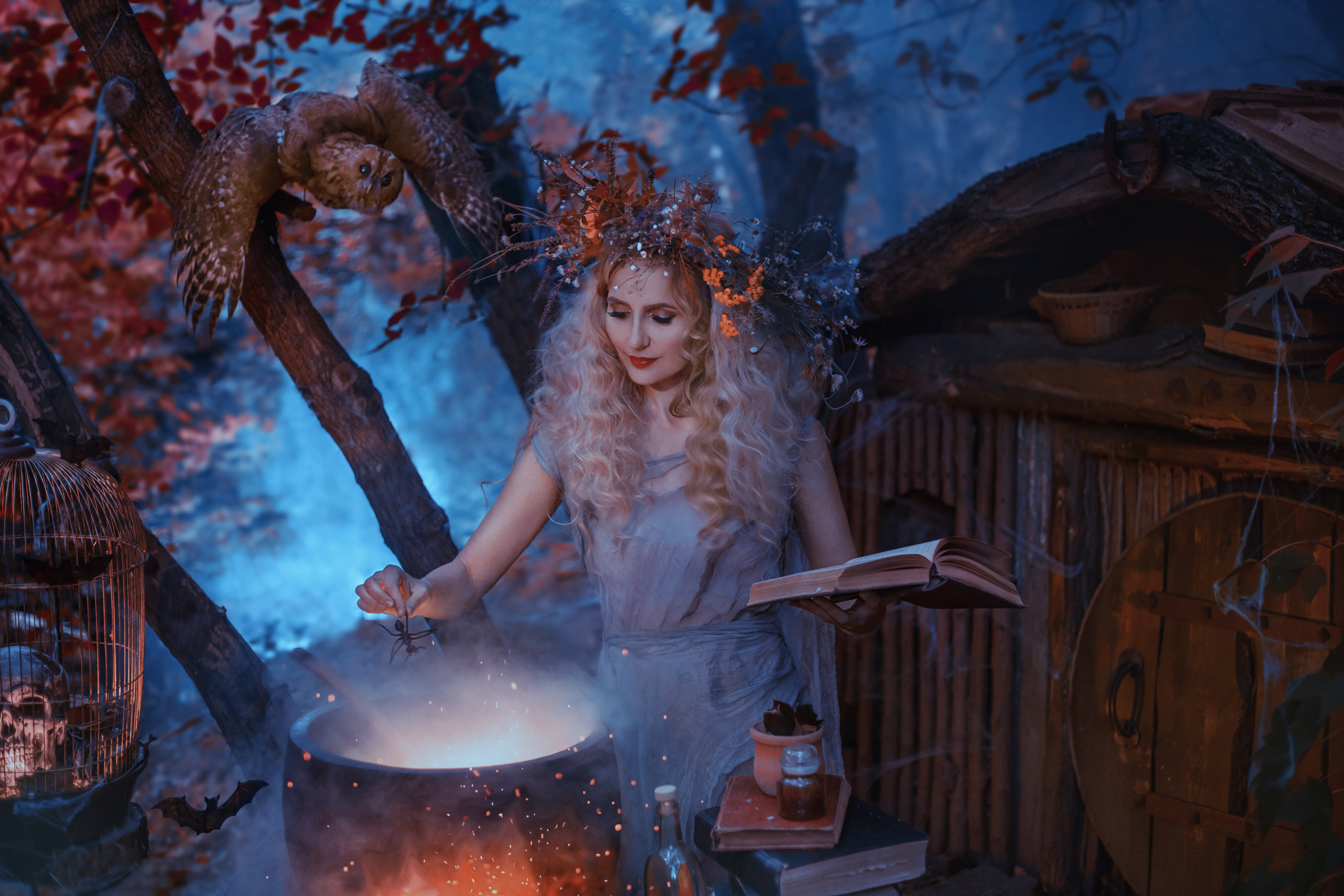 A witch in a forest adding items to a potion pot