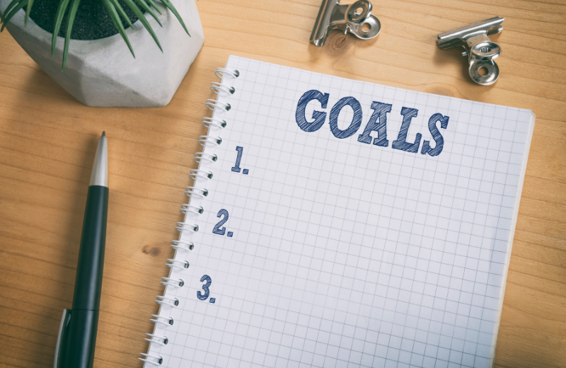 Image of a notebook saying 'goals' on it.