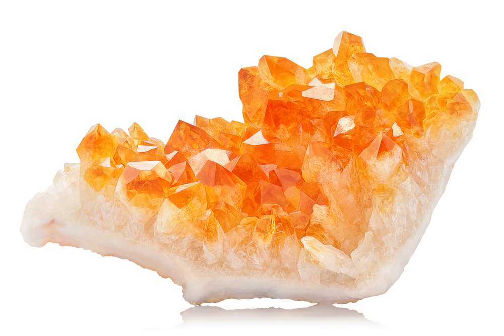 A raw piece of Citrine on a white background