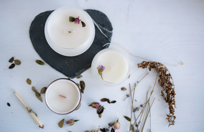 white candles and dried flowers