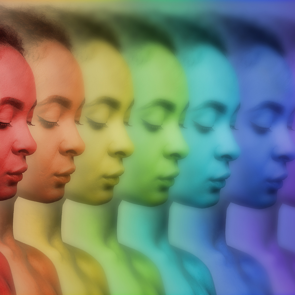 Repeating image of a woman in various colourful energy fields