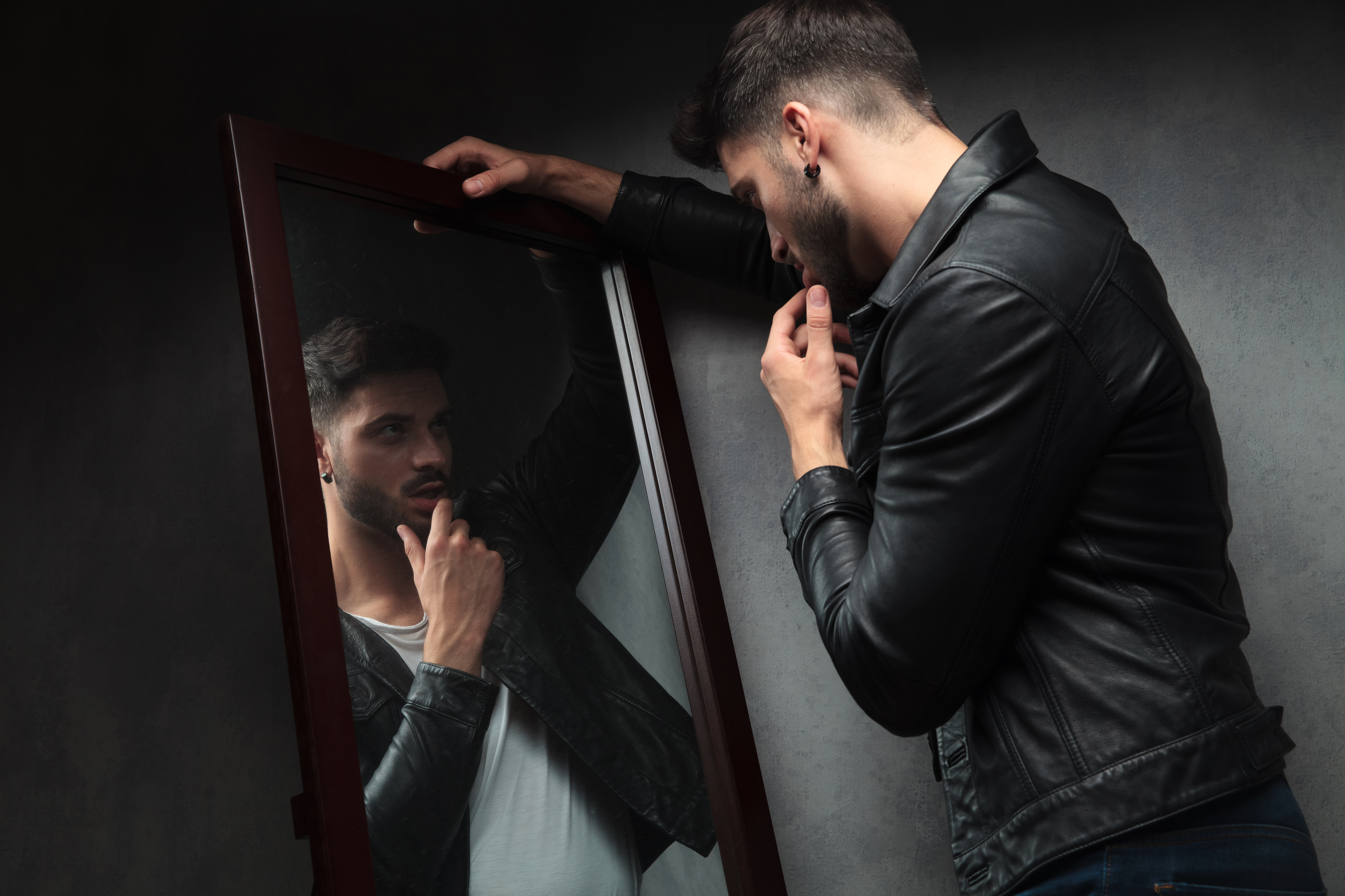 Narcissistic man admiring himself in the mirror