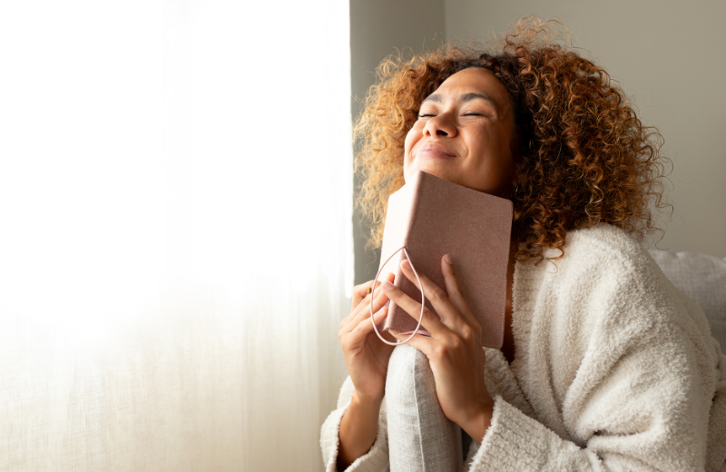 Happy woman journaling about the future