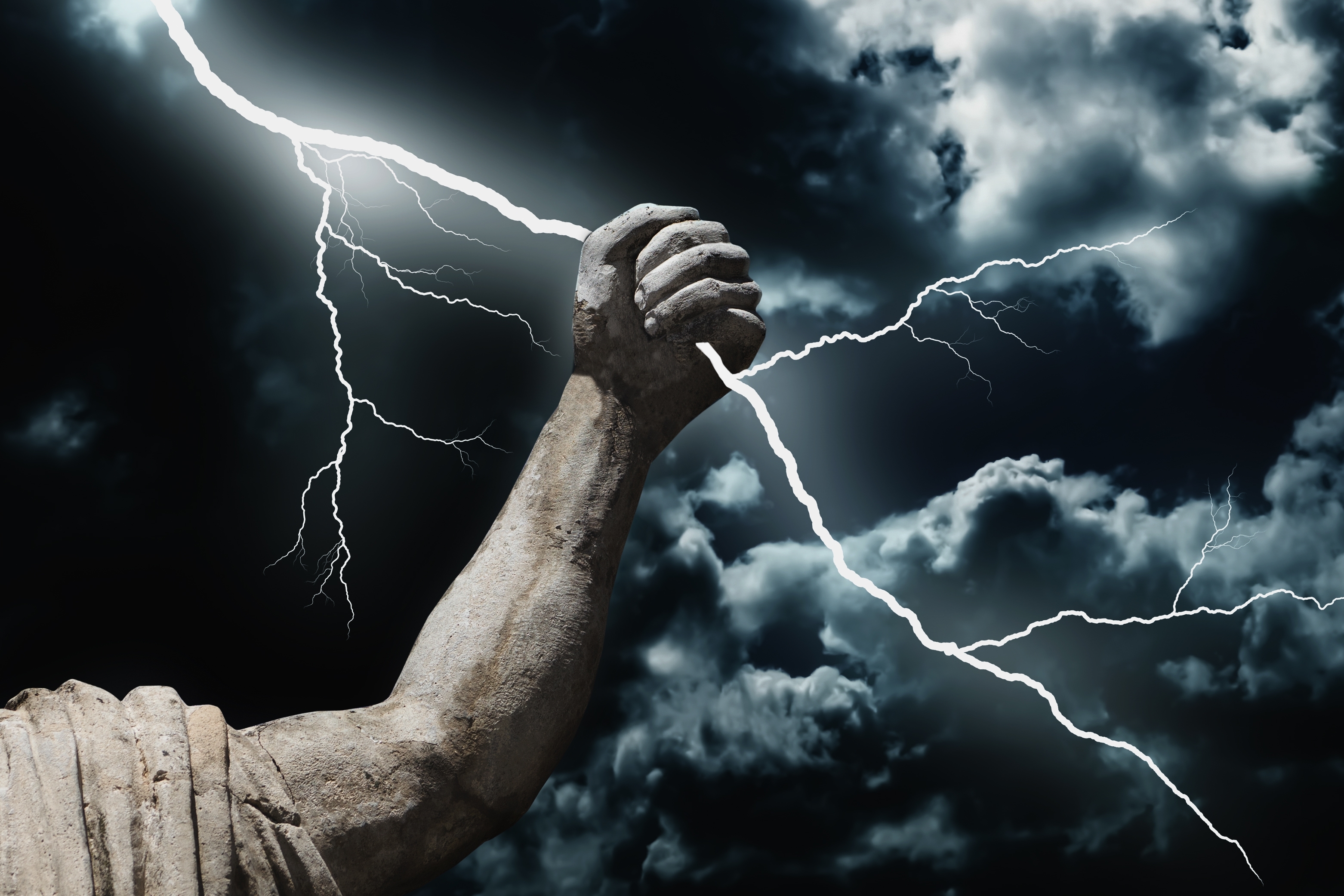 A statue's arm holding a lightning bolt