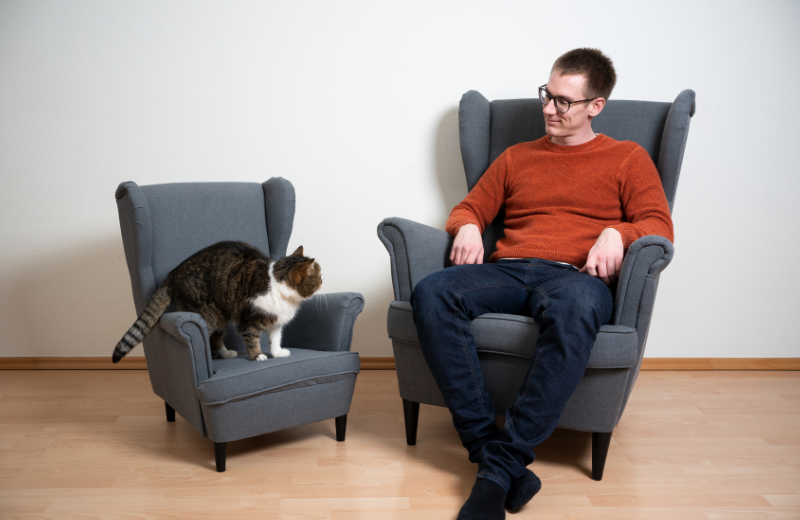 owner and cat sitting together