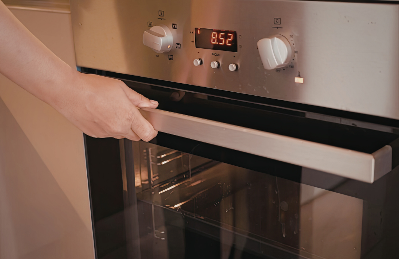 person about to open oven door
