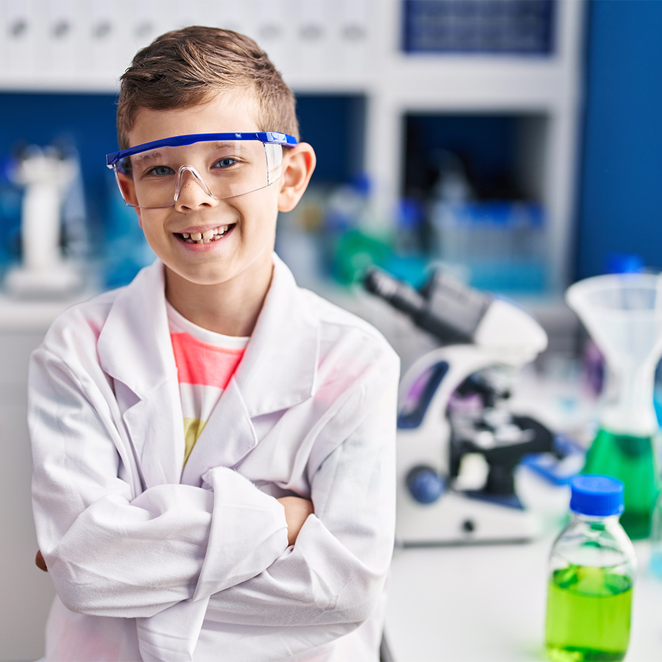 Child wearing a scientist's uniform in a laboratory