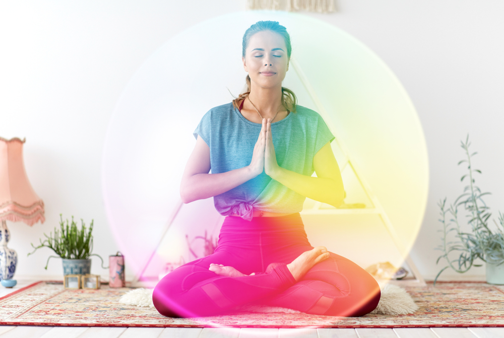 Woman meditating with visible aura around her