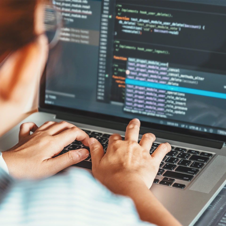 Woman coding on a laptop