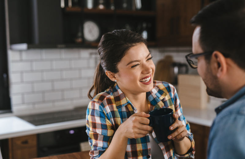 Couple smiling together in the kitchen
