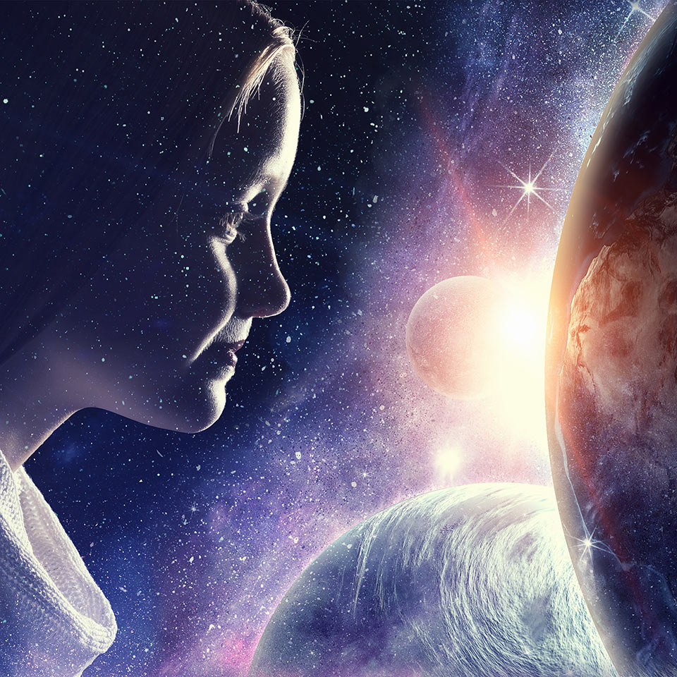 Girls face double-exposed with a space scene